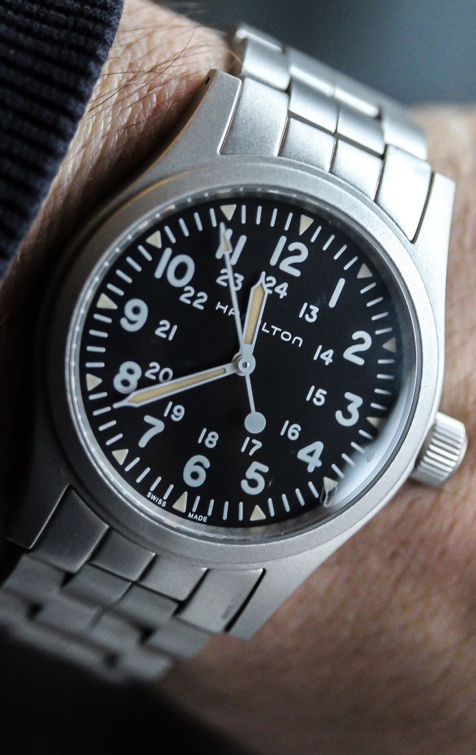Hamilton Khaki Field à cadran noir sur bracelet acier, au poignet